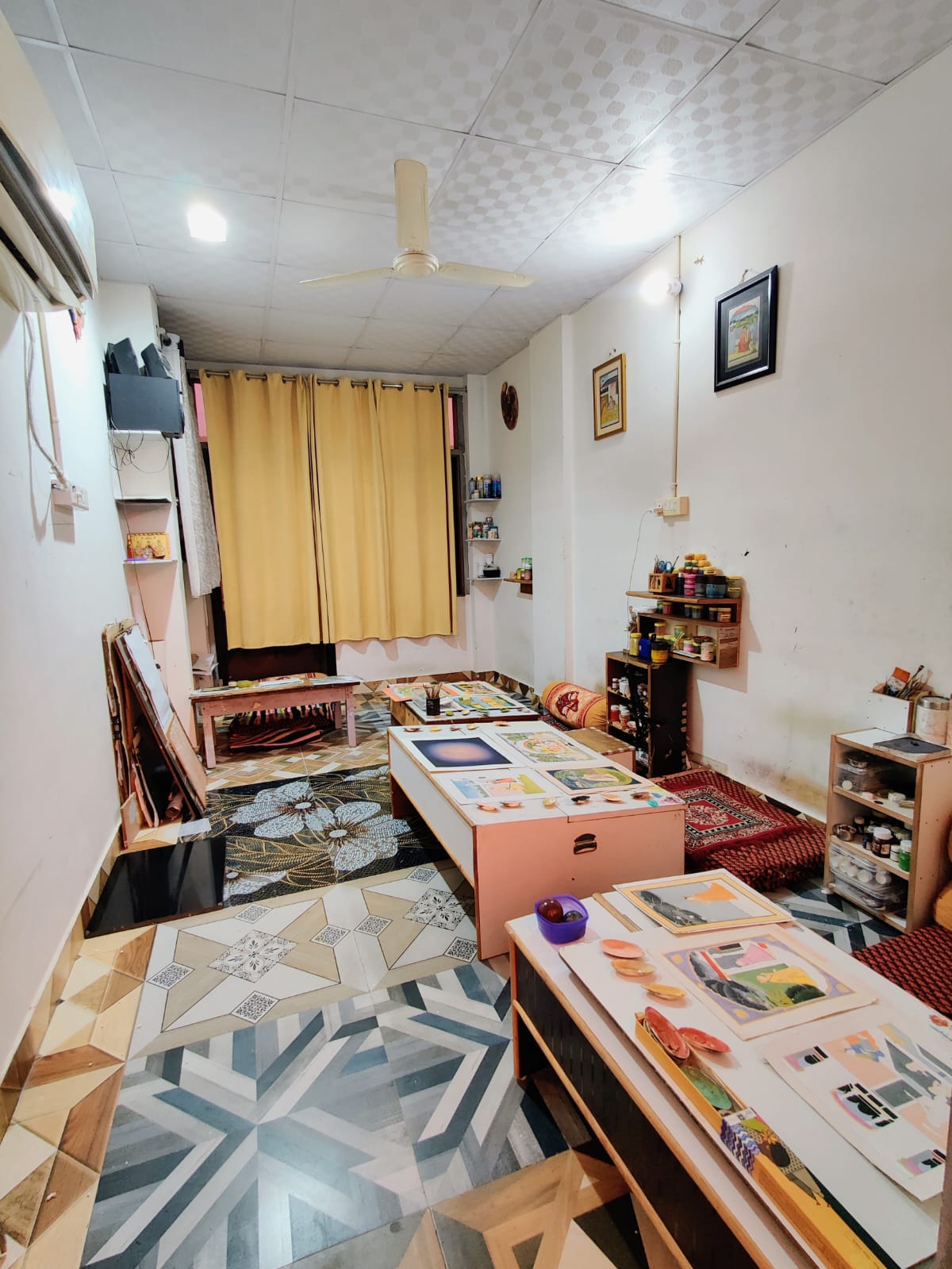 The artists' sunlit studio, filled with paintings and the tools of their craft